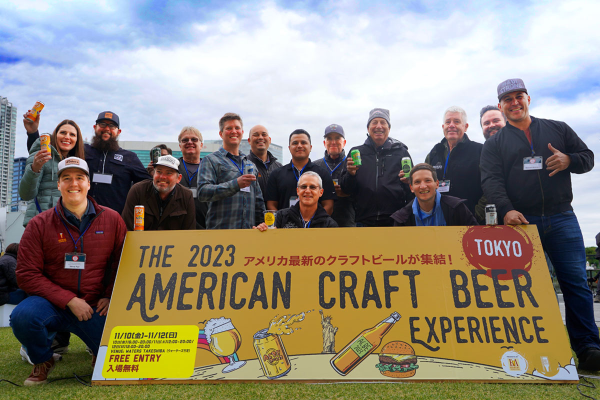 american craft beer experience participants posing in front of sign in tokyo