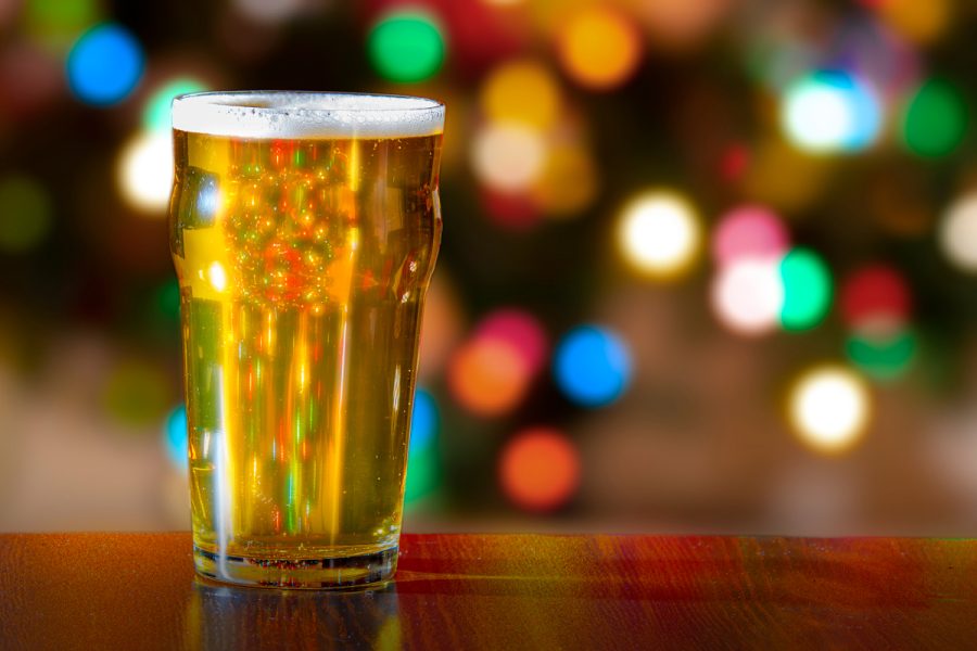 Beer on a bar with background holiday lights shining through it.