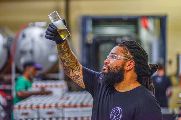 Brewer inspecting beer