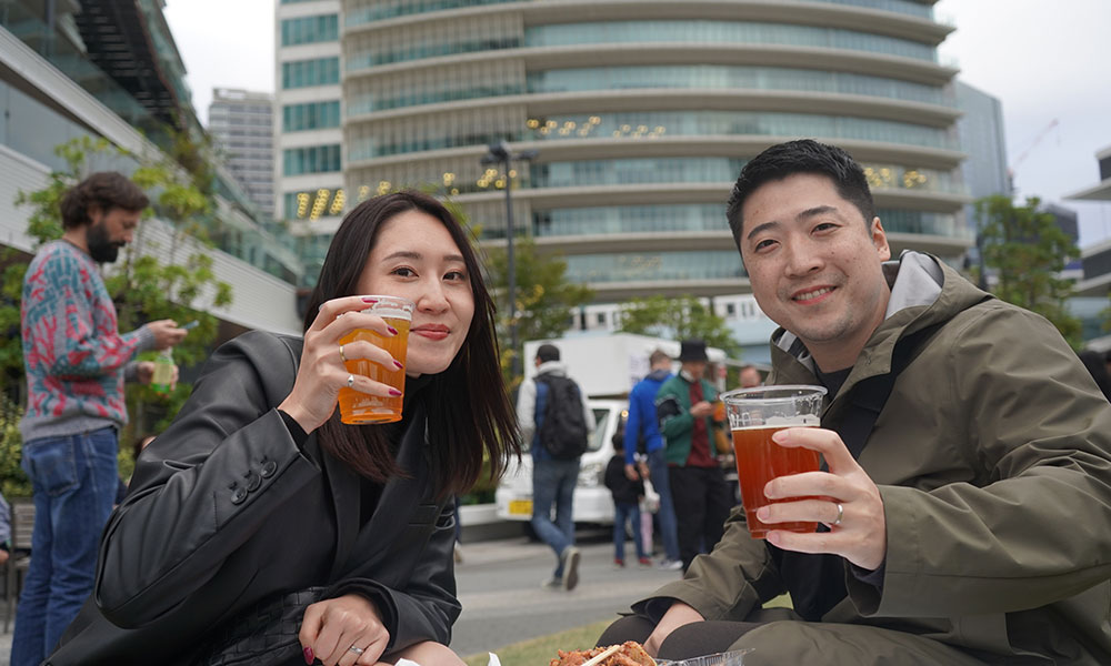 couple holding glasses at beer event in Tokyo