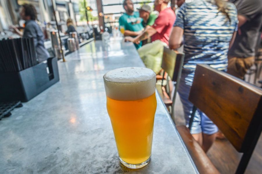 full ale sitting on bar counter in busy taproom