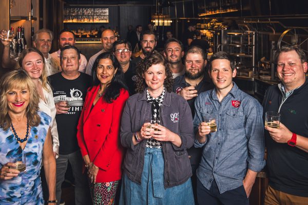 group of craft beer ambassadors posing together in brewery