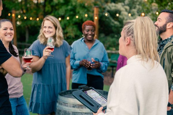 group of young people enjoying beer outdoors