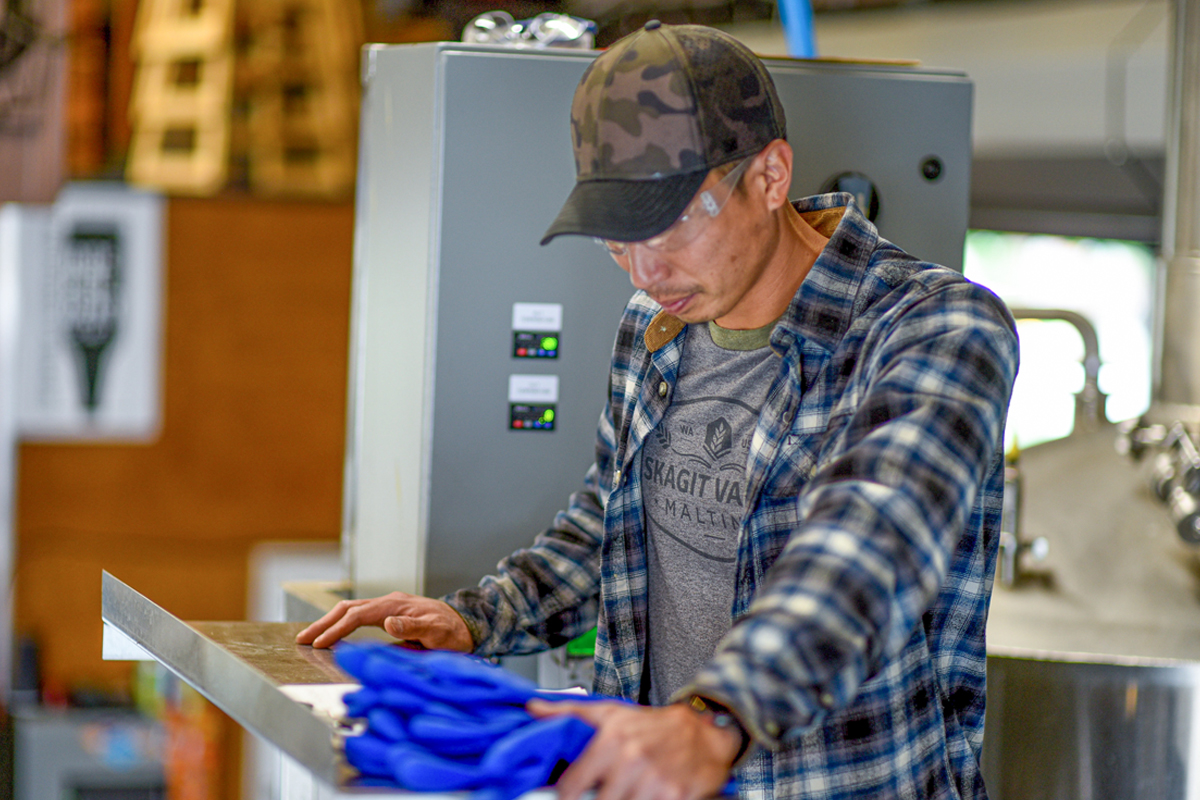 man reading paperwork in brewery