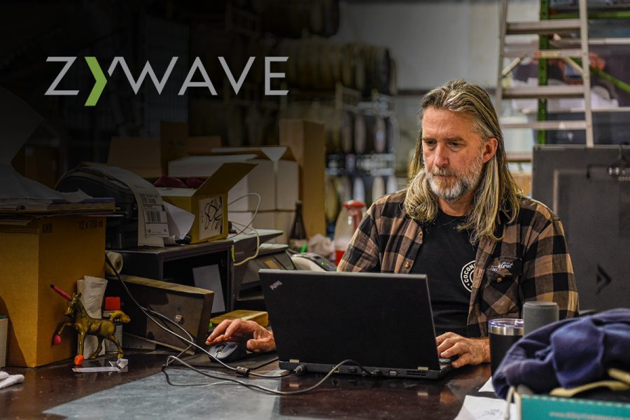 man working at computer in brewhouse with Zywave logo