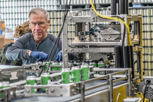 man working canning line