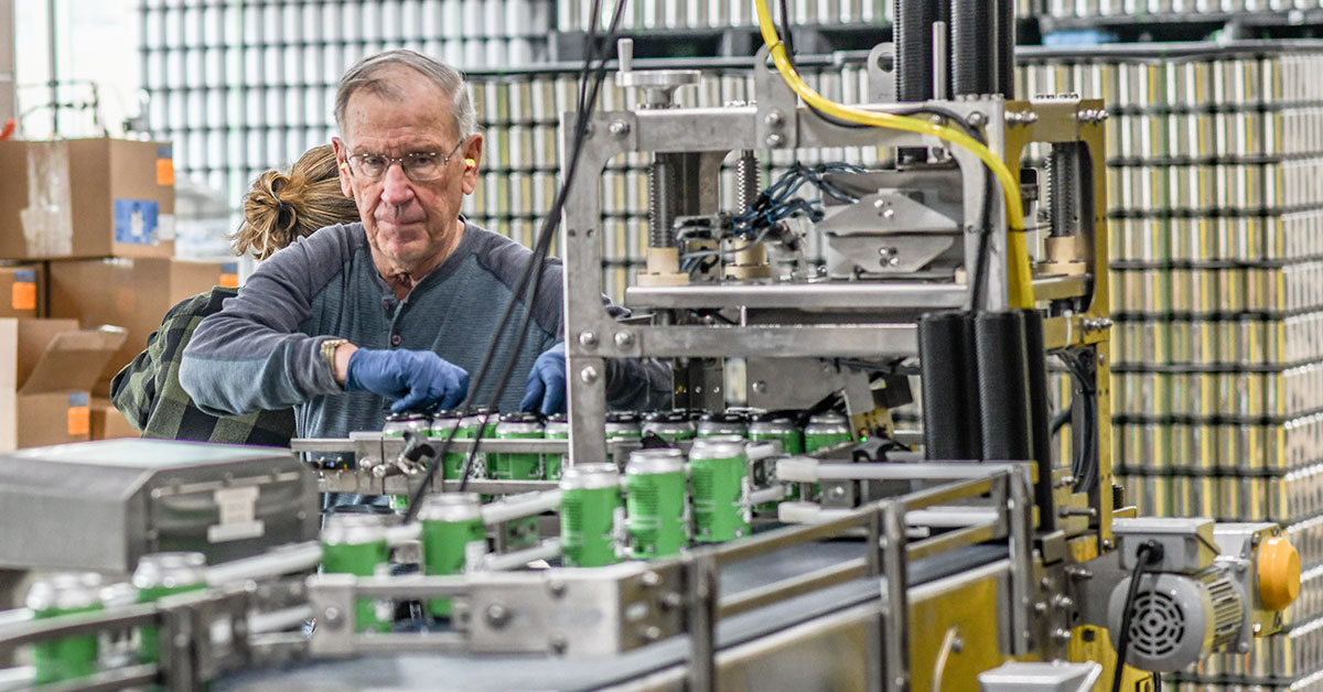 man working canning line