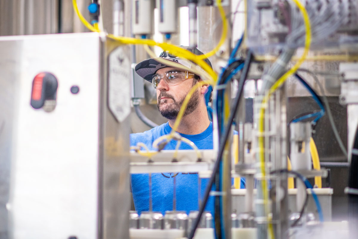 man working on canning line