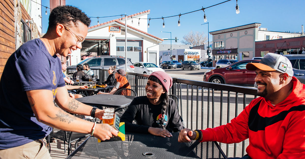 taproom server delivering taster glasses of beer to patrons 1200x628 1