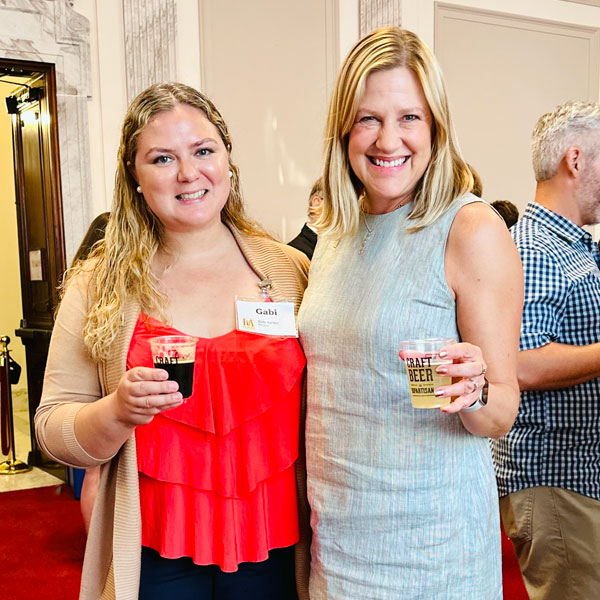 two women enjoying craft beer at event