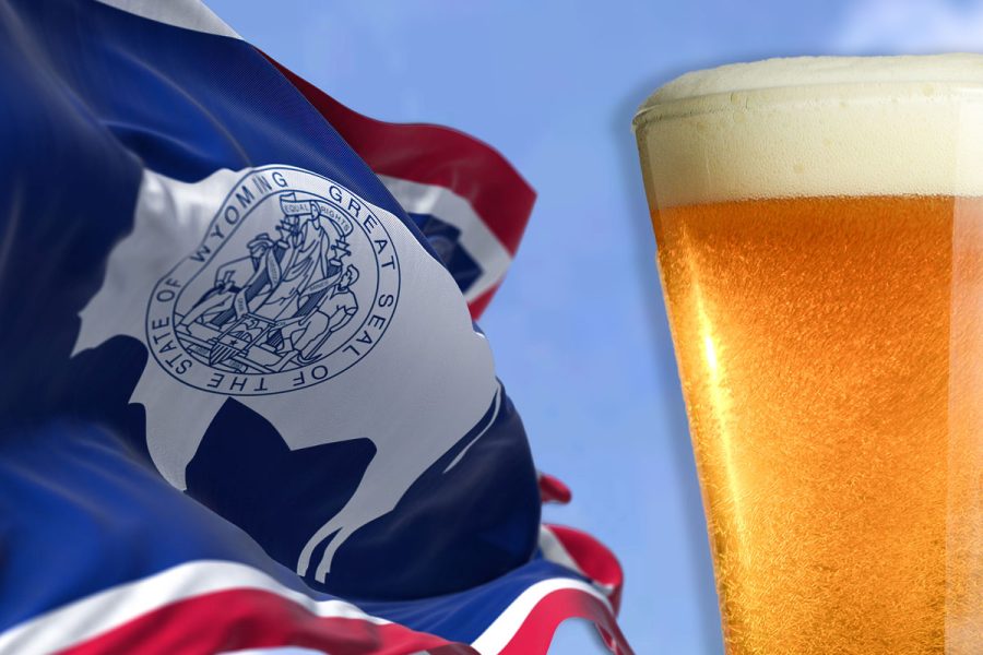 Wyoming flag fluttering next to glass of beer