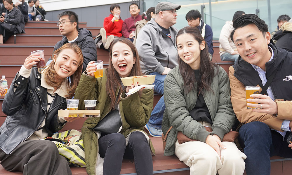 young smiling beer event attendees in tokyo